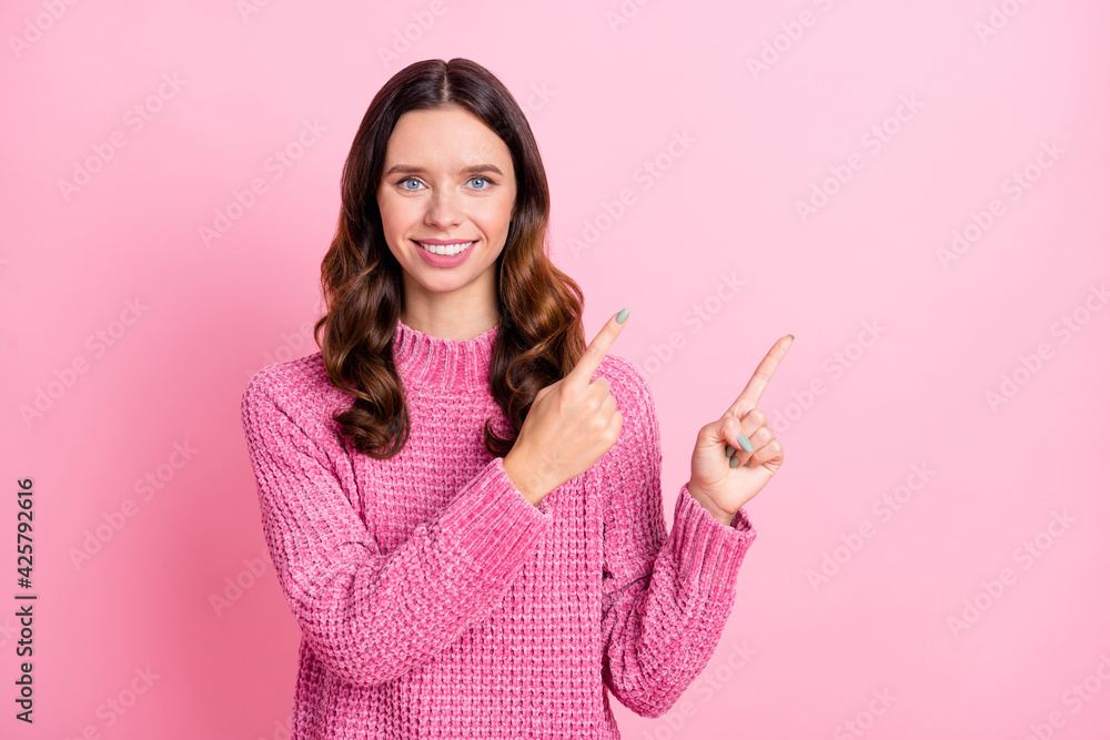 Photo of optimistic brunette lady point empty space wear pink sweater isolated on pastel pink color background Photo of optimistic brunette lady point empty space wear pink sweater isolated on pastel pink color background