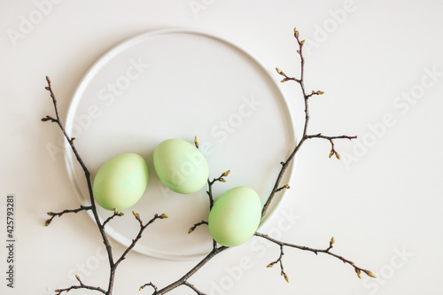 Green Easter eggs on a white plate