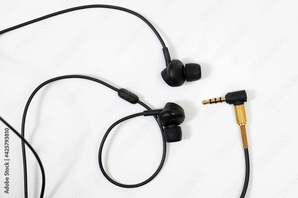 Top view in ear headphone isolate on white background , Black gold headphones. Top view in ear headphone isolate on white background , Black gold headphones.