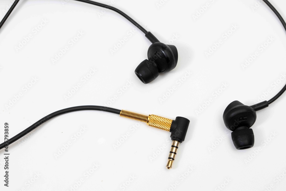 Top view in ear headphone isolate on white background , Black gold headphones. Top view in ear headphone isolate on white background , Black gold headphones.
