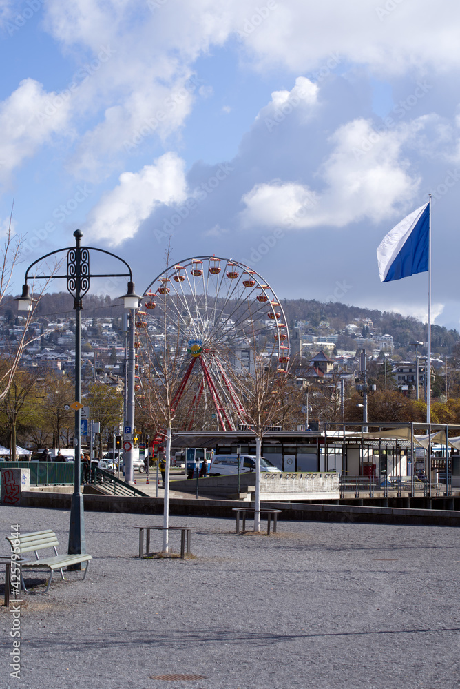 Obraz premium Square Burkliplatz at city of Zurich with flag of Zurich and ferris wheel in the background. Photo taken April 6th, 2021, Zurich, Switzerland.