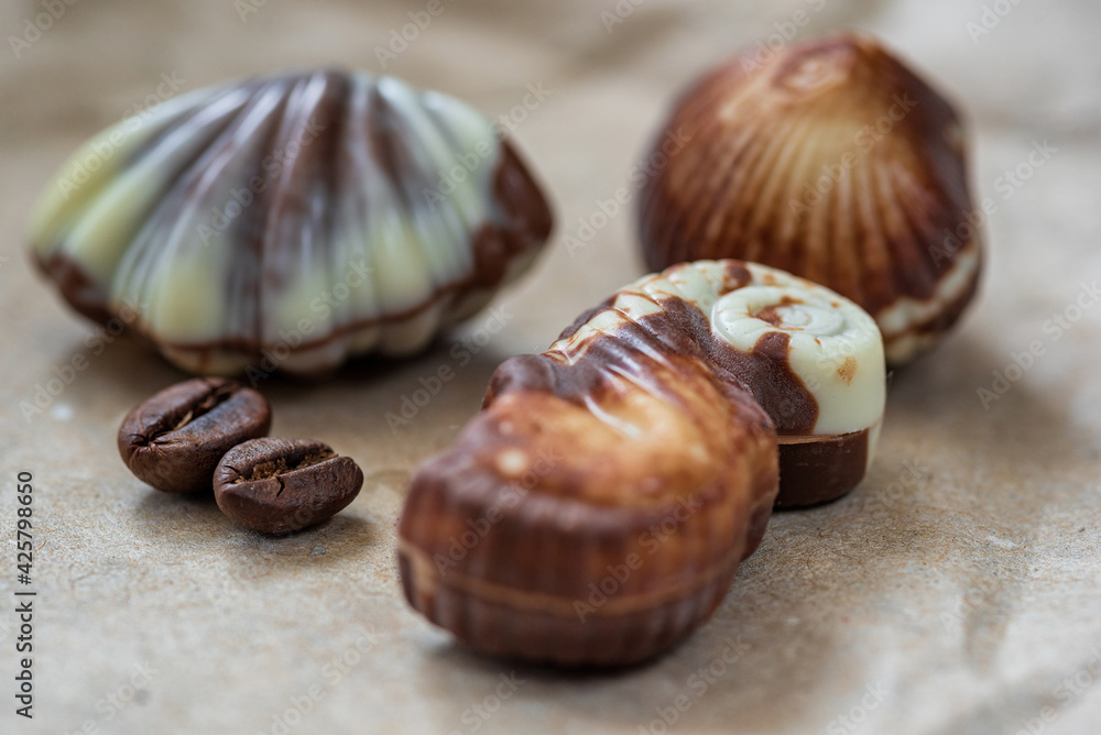 Figurines of Belgian chocolate on a paper background close-up.
