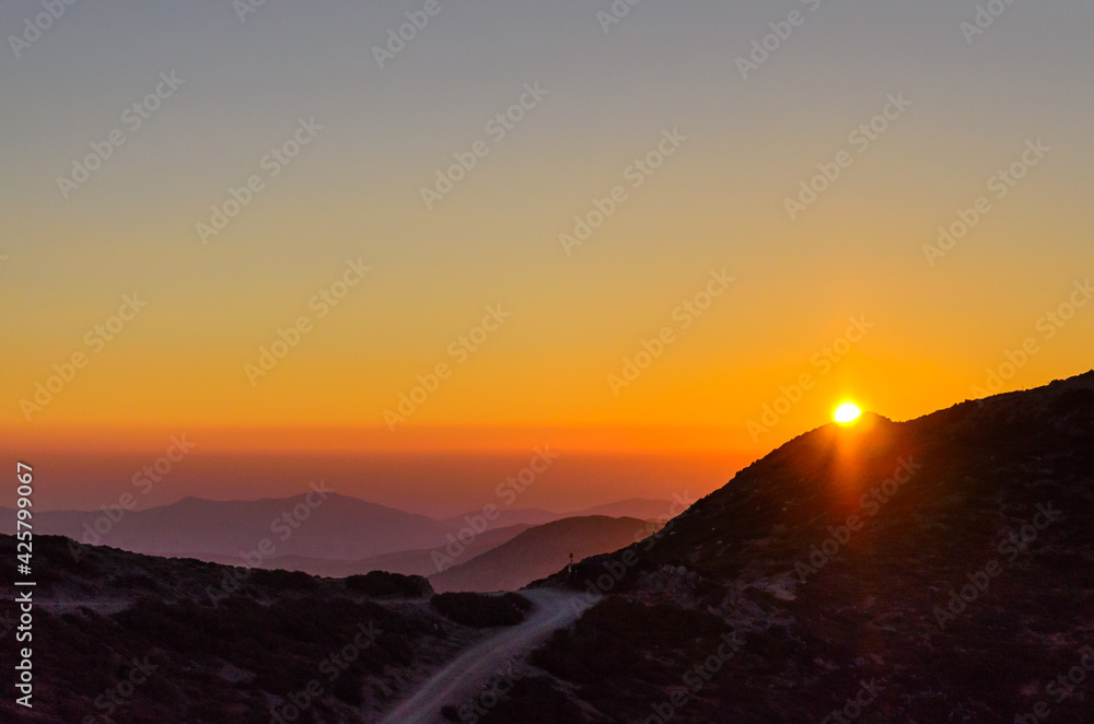 Aerial View of a Beautiful Sunset over the Mountains of Crete Island, Greece. Panoramic View of the Horizon from the Mountain Top. Natural Scenery with the Sun Fading.