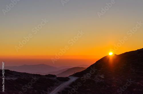 Aerial View of a Beautiful Sunset over the Mountains of Crete Island  Greece. Panoramic View of the Horizon from the Mountain Top. Natural Scenery with the Sun Fading.