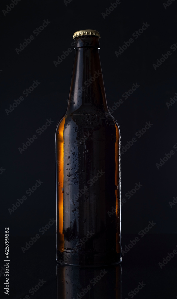 bottle of beer on a black background. Advertising photo