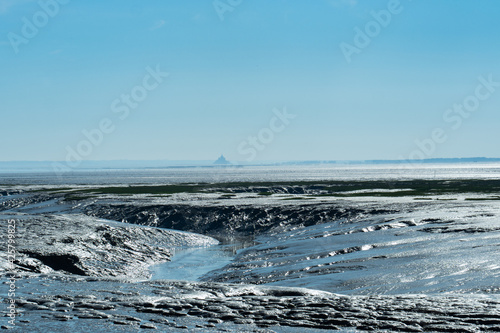 Sea floor during low tide in Brittany, France. Far away Mont-Saint-Michel