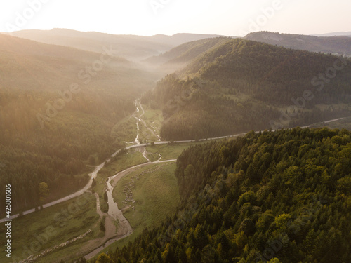Aerial view to road with moutains captured from above © bartoshd