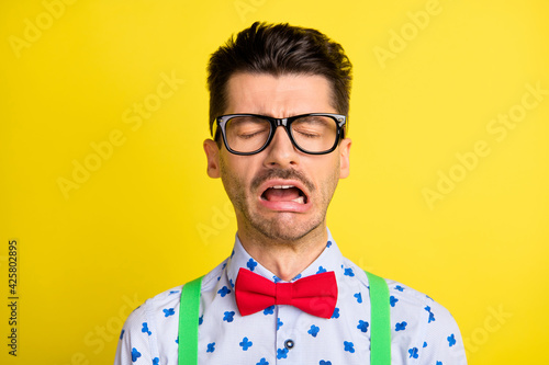 Photo of young man unhappy sad upset depressed cry offended fail isolated over yellow color background © deagreez