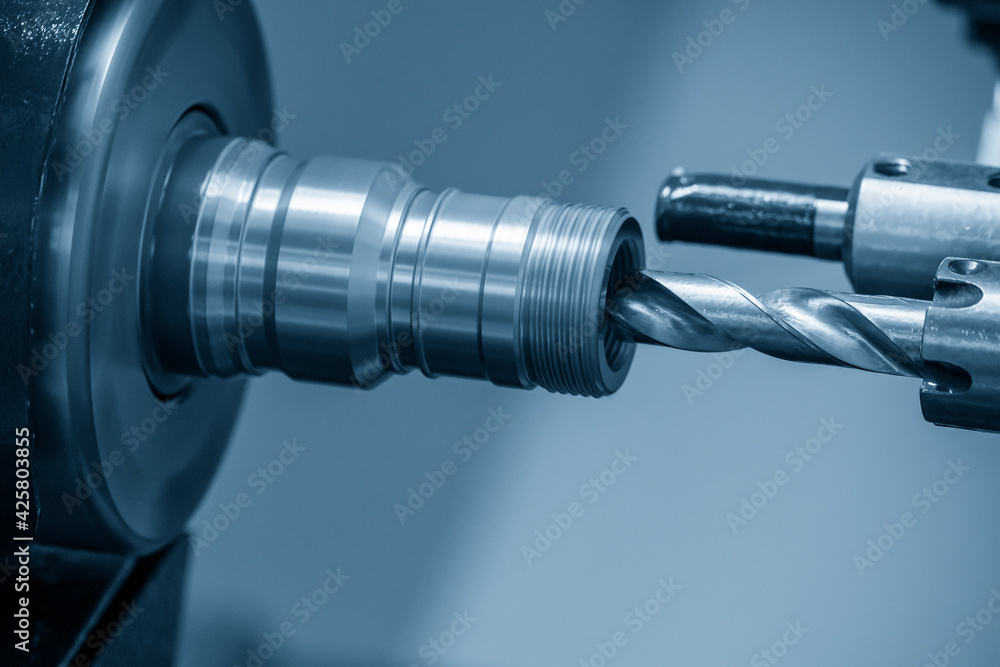 The CNC lathe machine drilling the pipe connector parts. The hi-technology metal working processing by CNC turning machine . The CNC lathe machine drilling the pipe connector parts. The hi-technology metal working processing by CNC turning machine .