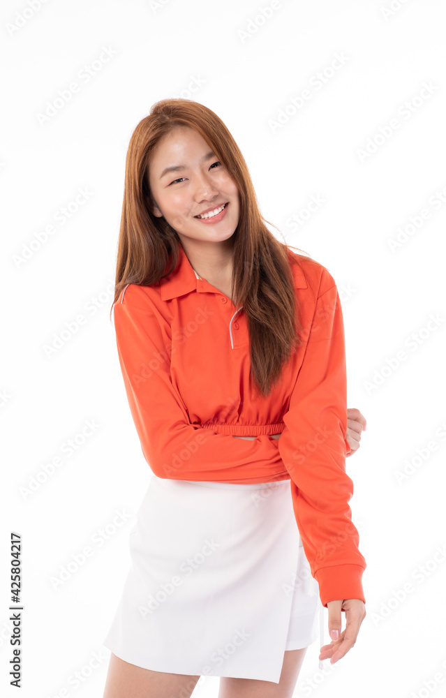Young beautiful Asian woman smiling happy on white background. Young happy teen wears bright orange clothes. Asian girl in studio, pose feeling happy in studio light portrait. Young beautiful Asian woman smiling happy on white background. Young happy teen wears bright orange clothes. Asian girl in studio, pose feeling happy in studio light portrait.