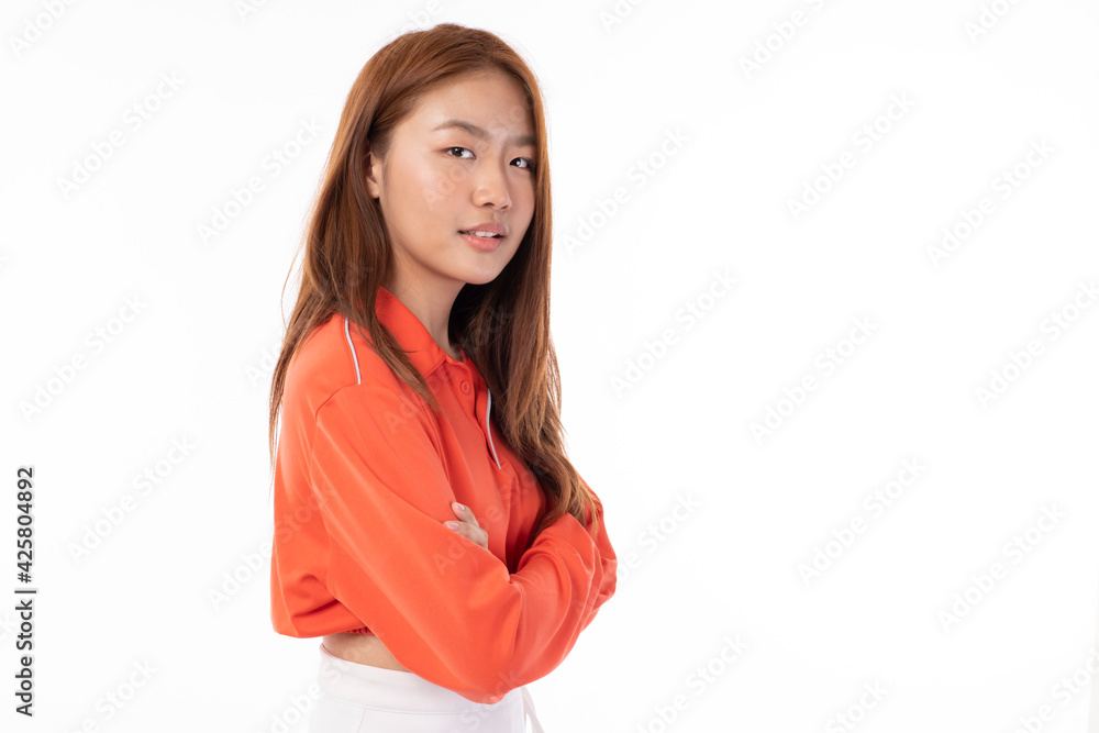 Young beautiful Asian woman smiling happy on white background. Young happy teen wears bright orange clothes. Asian girl in studio, pose feeling happy in studio light portrait. Young beautiful Asian woman smiling happy on white background. Young happy teen wears bright orange clothes. Asian girl in studio, pose feeling happy in studio light portrait.