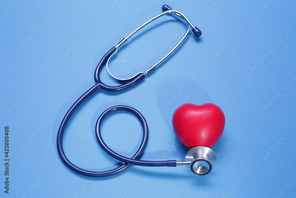 Red heart shape and stethoscope on blue background Red heart shape and stethoscope on blue background