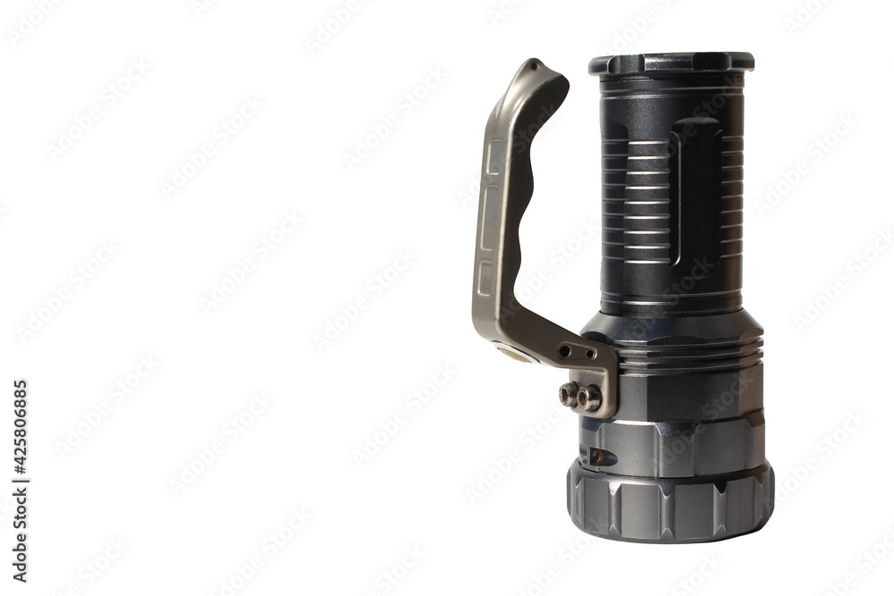 A flashlight from an iron body stands on a white background A flashlight from an iron body stands on a white background