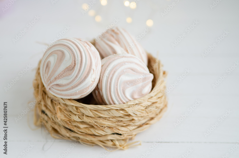 Coffee marshmallow on a white wooden background with yellow bokke. Light dessert for the holiday