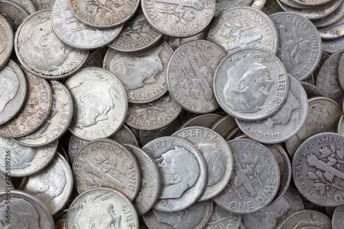 Very close view of old silver dimes illuminated with natural light. photo