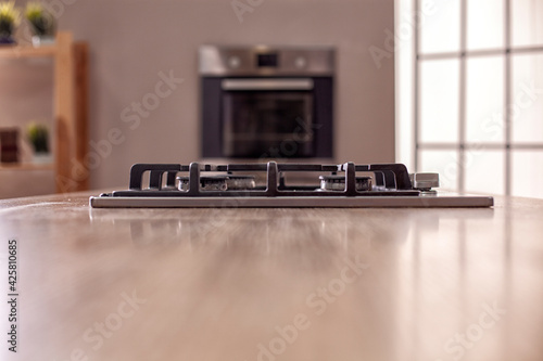 Silver pan on a modern silver gas stove in the kitchen close-up. photo