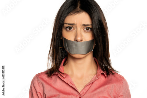 Woman with tape over mouth, isolated on white.