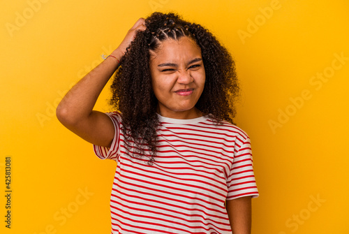 Young african american woman isolated on yellow background forgetting something, slapping forehead with palm and closing eyes.