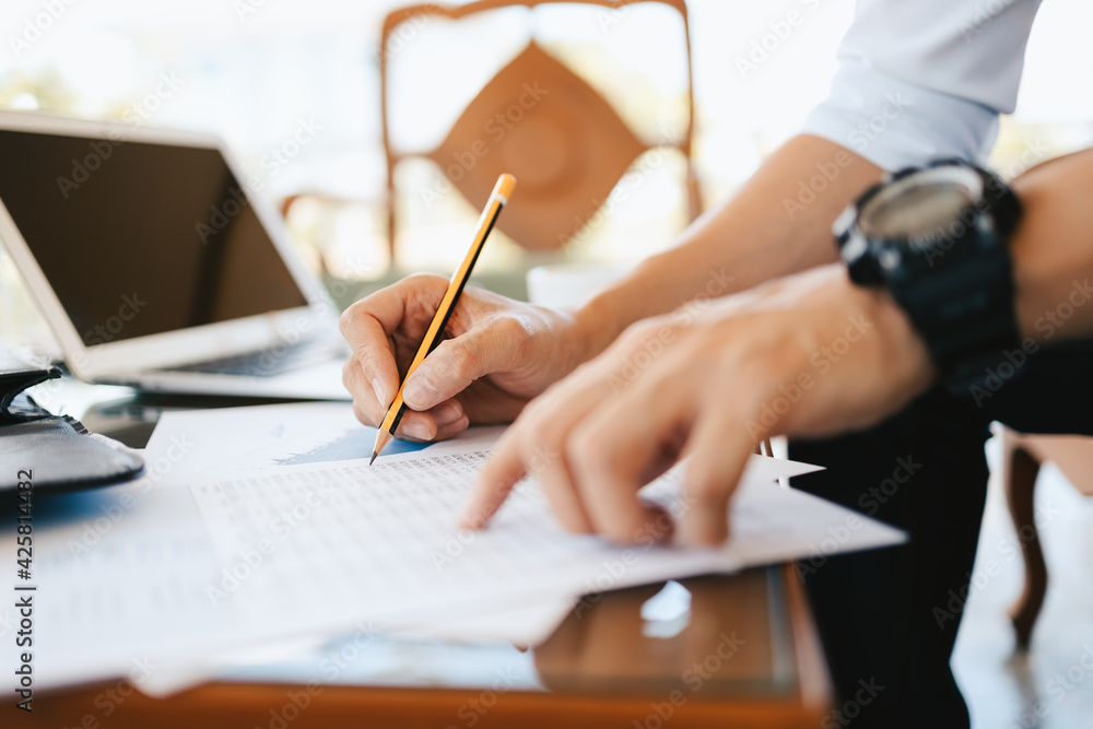 Administrator businessman making report, calculating balance. Business analyzing income charts, graphs and data on the table. Administrator businessman making report, calculating balance. Business analyzing income charts, graphs and data on the table.