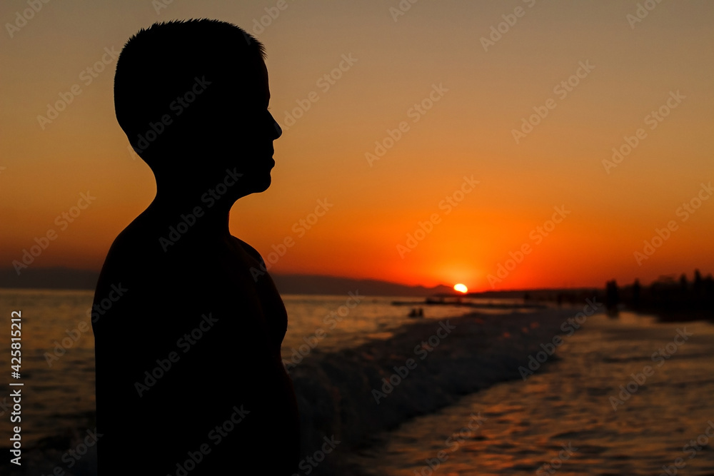 silhouette of child at sunset at sea silhouette of child at sunset at sea