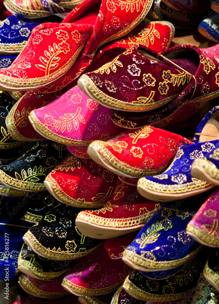 Multicolor slippers in a pile in a market stall