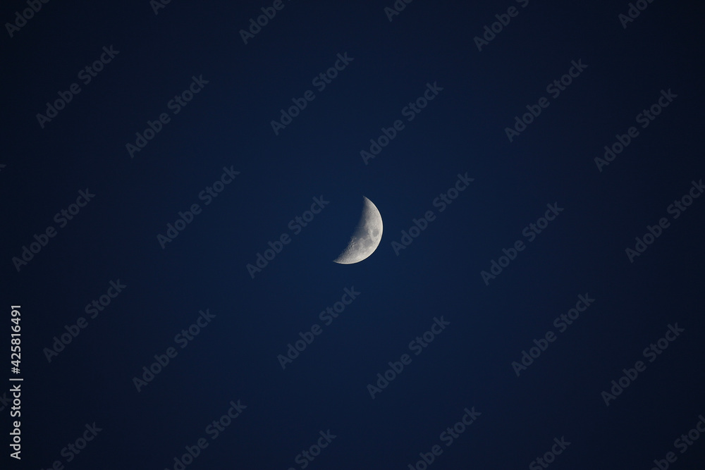 Brightly shining moon in a cloudless night sky Brightly shining moon in a cloudless night sky