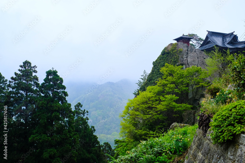 Traditional Japanese house located on the peak of mountain,morning peaceful time on the hill against beautiful view of misty cover on green forest in Japan. Traditional Japanese house located on the peak of mountain,morning peaceful time on the hill against beautiful view of misty cover on green forest in Japan.