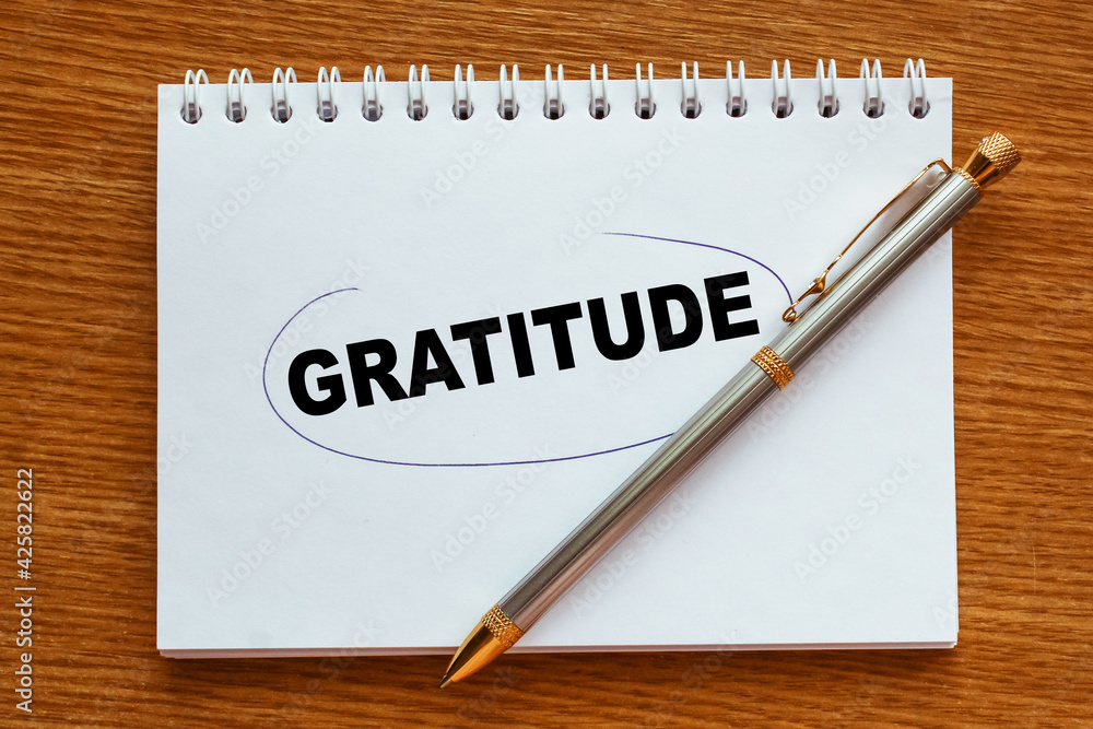 text GRATITUDE in notepad. office furniture on the table. business and finance text GRATITUDE in notepad. office furniture on the table. business and finance