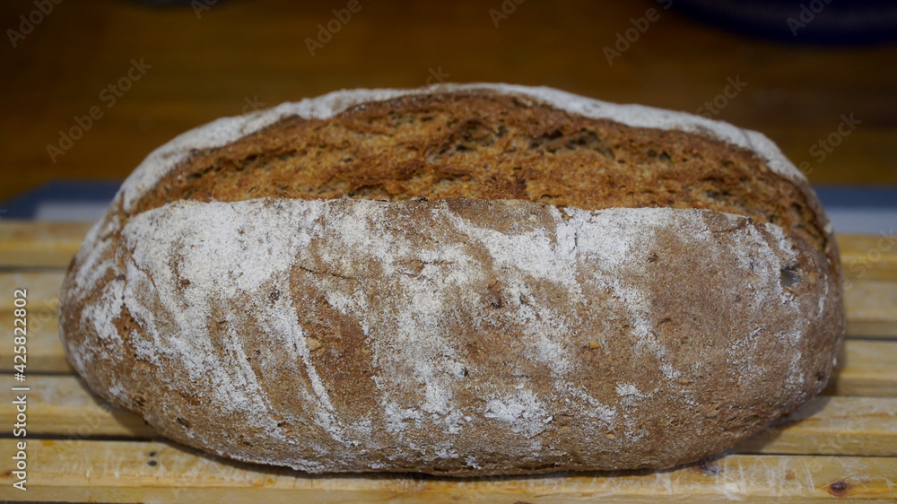 Homemade bread taken out of the oven and left to rest. Indoor photography. Product photography.