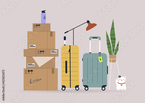 A relocation concept, cardboard boxes and suitcases with personal belongings and interior objects, moving to a new apartment, a storage service