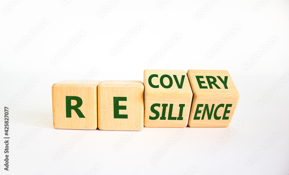 Recovery and resilience symbol. Turned cubes and changed the word 'recovery' to 'resilience'. Beautiful white background. Business and recovery - resilience concept. Copy space.