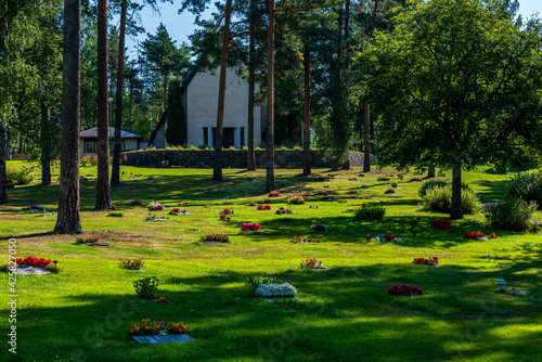 Photos Cemetery with many graves decorated with colorful flowers