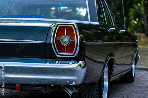Close up of the tail light of a classic car from the sixties