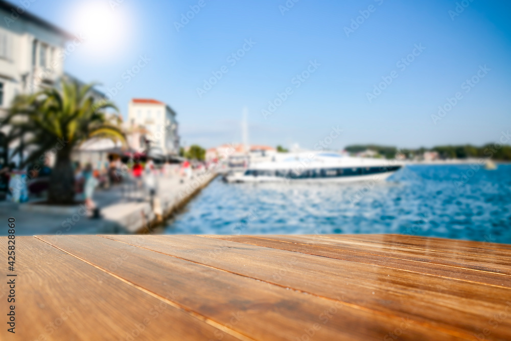 Fototapeta premium Sunset on the seashore and wooden table in the evening 