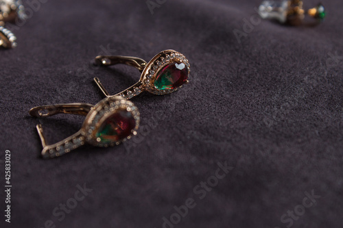Multi-colored gold earrings. Jewelry close-up. A gift for a woman.