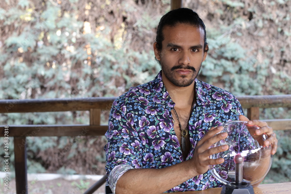 Fototapeta premium Handsome fortune teller with crystal ball 