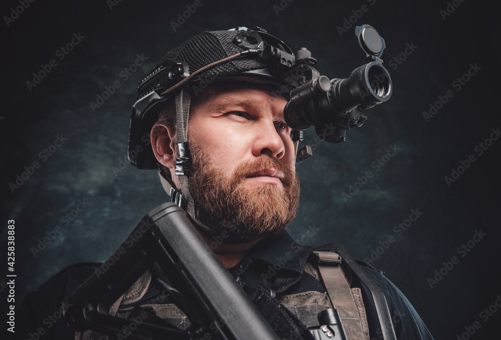 Modern soldier looks in night vision device inbuilt in his helmet Modern soldier looks in night vision device inbuilt in his helmet