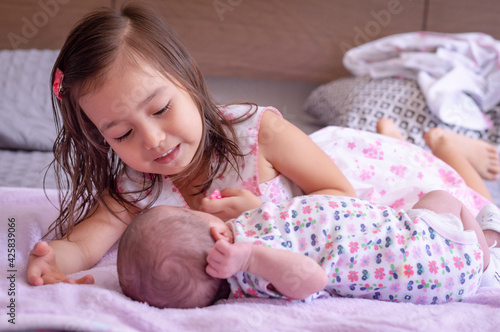 cute big sister with new newborn baby