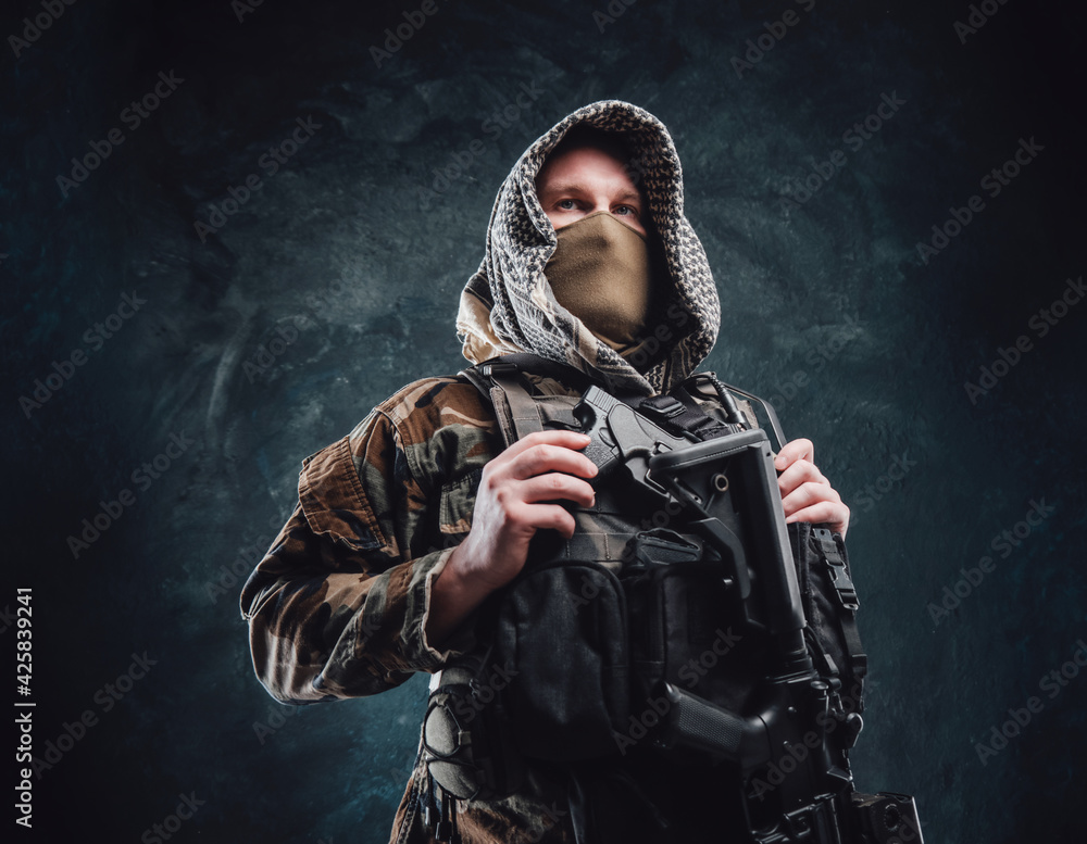 Soldier assassin with a hood and a rifle in dark background Soldier assassin with a hood and a rifle in dark background