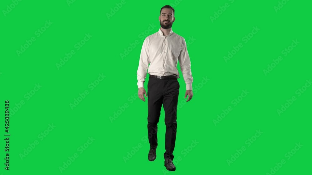 Confident happy successful business man walking and looking at camera. Full length on green screen chroma background. Confident happy successful business man walking and looking at camera. Full length on green screen chroma background.