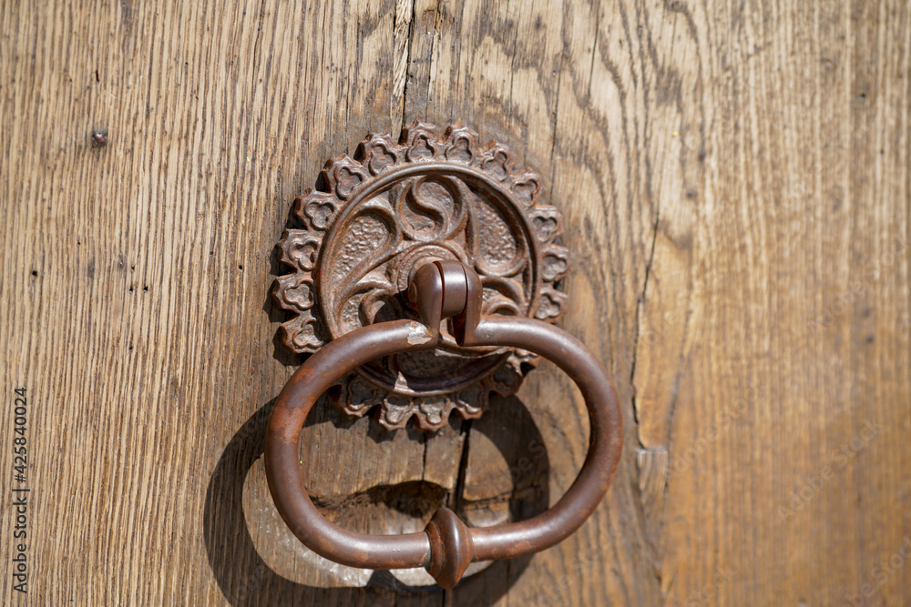 Door lock and door knocker on old doors photographed in daylight Door lock and door knocker on old doors photographed in daylight