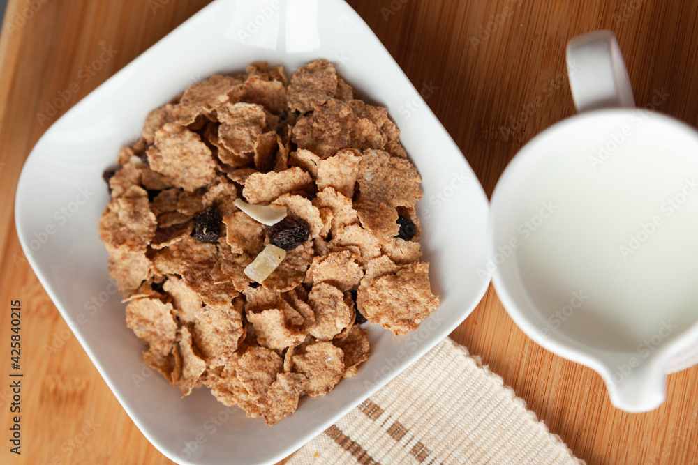 Good start to the day to have the right meal, healthy breakfast in bed with cornflakes and dried fruits and milk. Perfect nutrition for vegetarians. Good start to the day to have the right meal, healthy breakfast in bed with cornflakes and dried fruits and milk. Perfect nutrition for vegetarians.