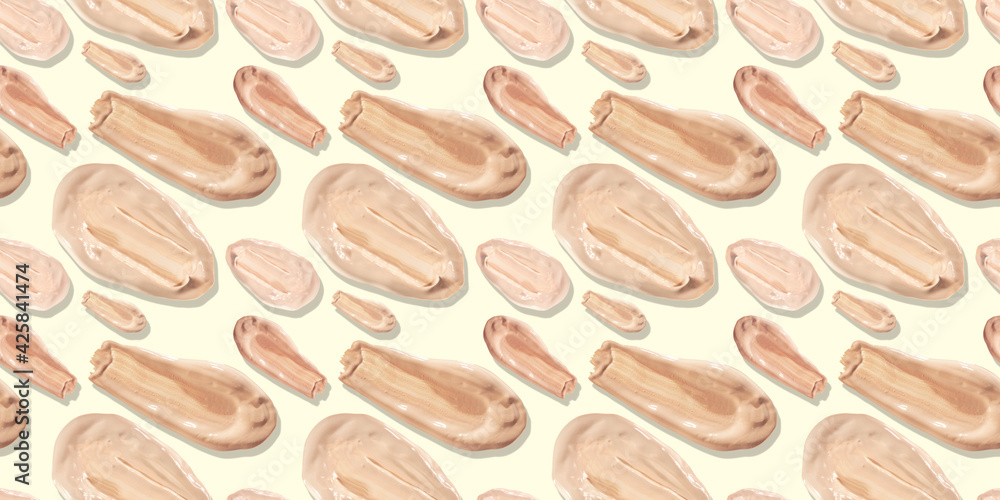 Seamless pattern of liquid foundation cream swatch smear. Light beige makeup concealer stroke on a pale yellow background. Nude makeup base swipe Seamless pattern of liquid foundation cream swatch smear. Light beige makeup concealer stroke on a pale yellow background. Nude makeup base swipe