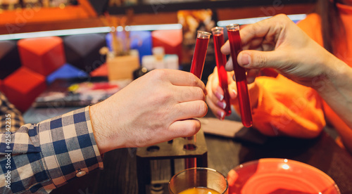 Fotografie Clinking glasses with alcohol and toasting, party.