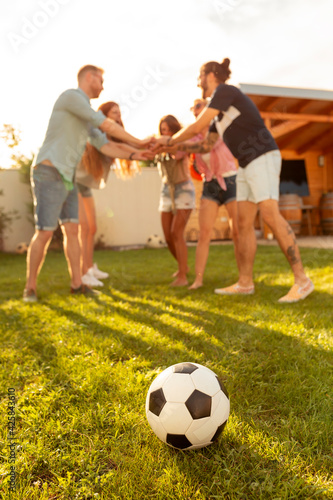 Fototapeta Naklejka Na Ścianę i Meble -  Friends gathered in circle during time out while playing football