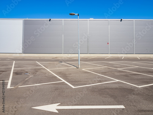 Empty parking in front of an aluminium cladding modern building