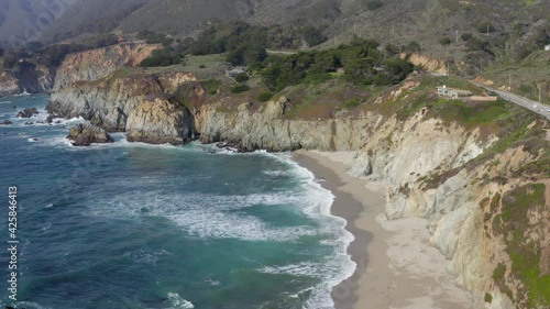 Pan from Bixby Creek Bridge on State Route 1 to an Aerial View of Big Sur Coast