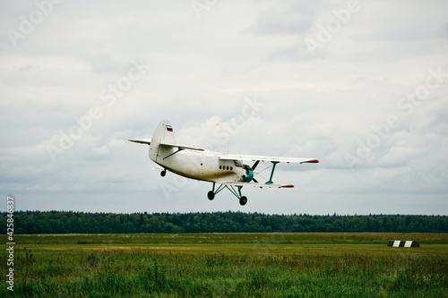 Private aircraft. Light aircraft flying over the field