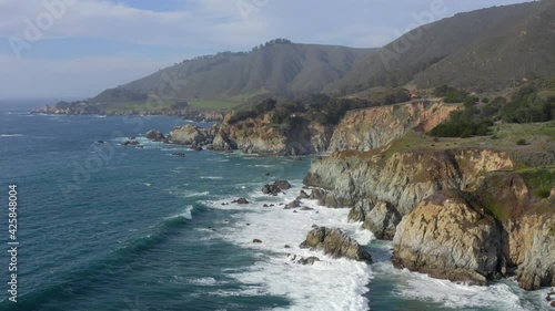 Forward Aerial Pan of Waves Crashing on the Rocky Shores of Big Sur California