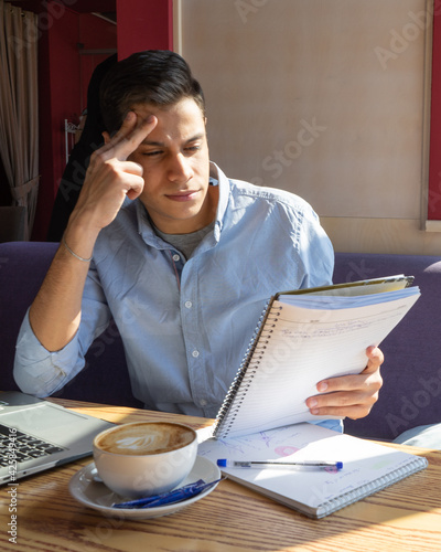 businessman ponders a solution while completing a biology project